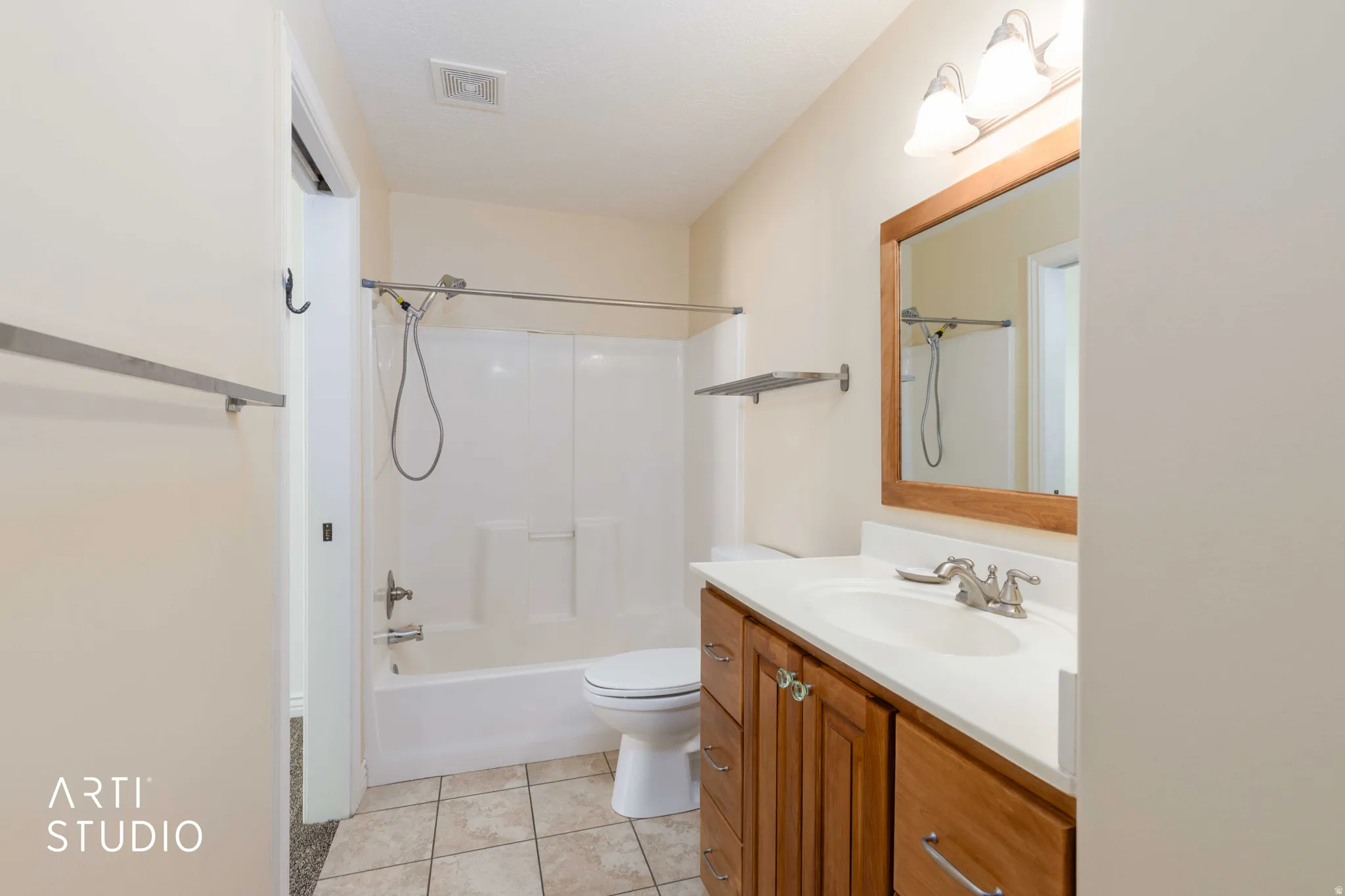 Full bath with vanity, washtub / shower combination, and light tile patterned floors