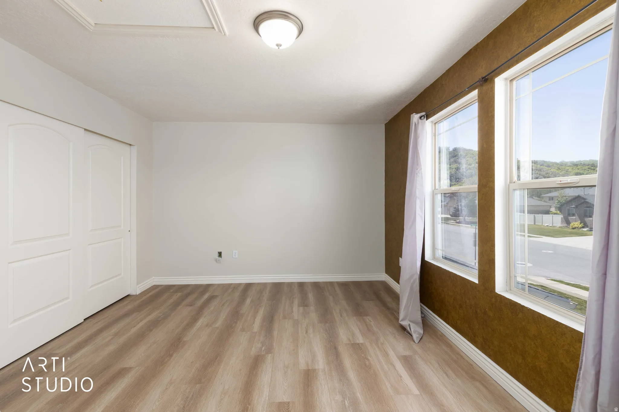 Unfurnished bedroom with light wood-style floors and a closet