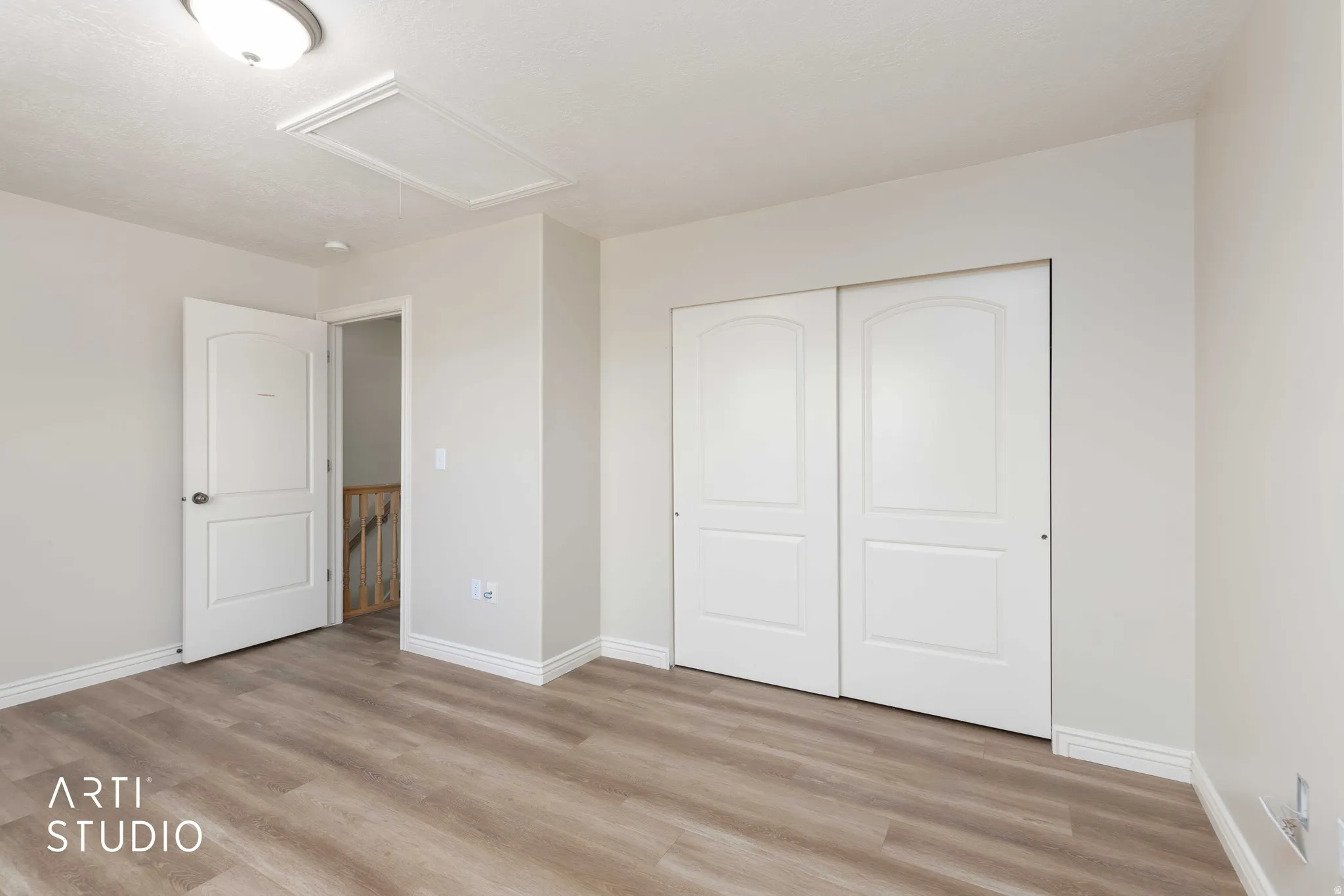 Unfurnished bedroom featuring light wood-style floors and a closet