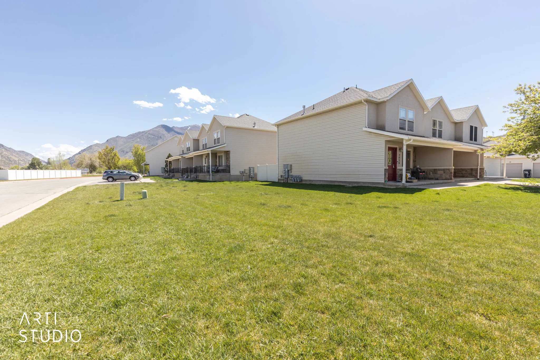 View of side of home featuring a mountain view, a patio, and stone siding