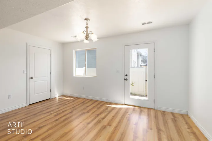 Entryway featuring a chandelier, light wood-style flooring, and a textured ceiling