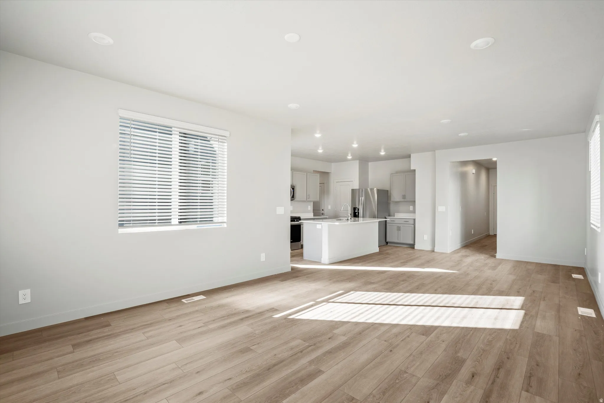 **DISCLAIMER** Interior package & color may vary. Unfurnished living room with light wood finished floors and baseboards