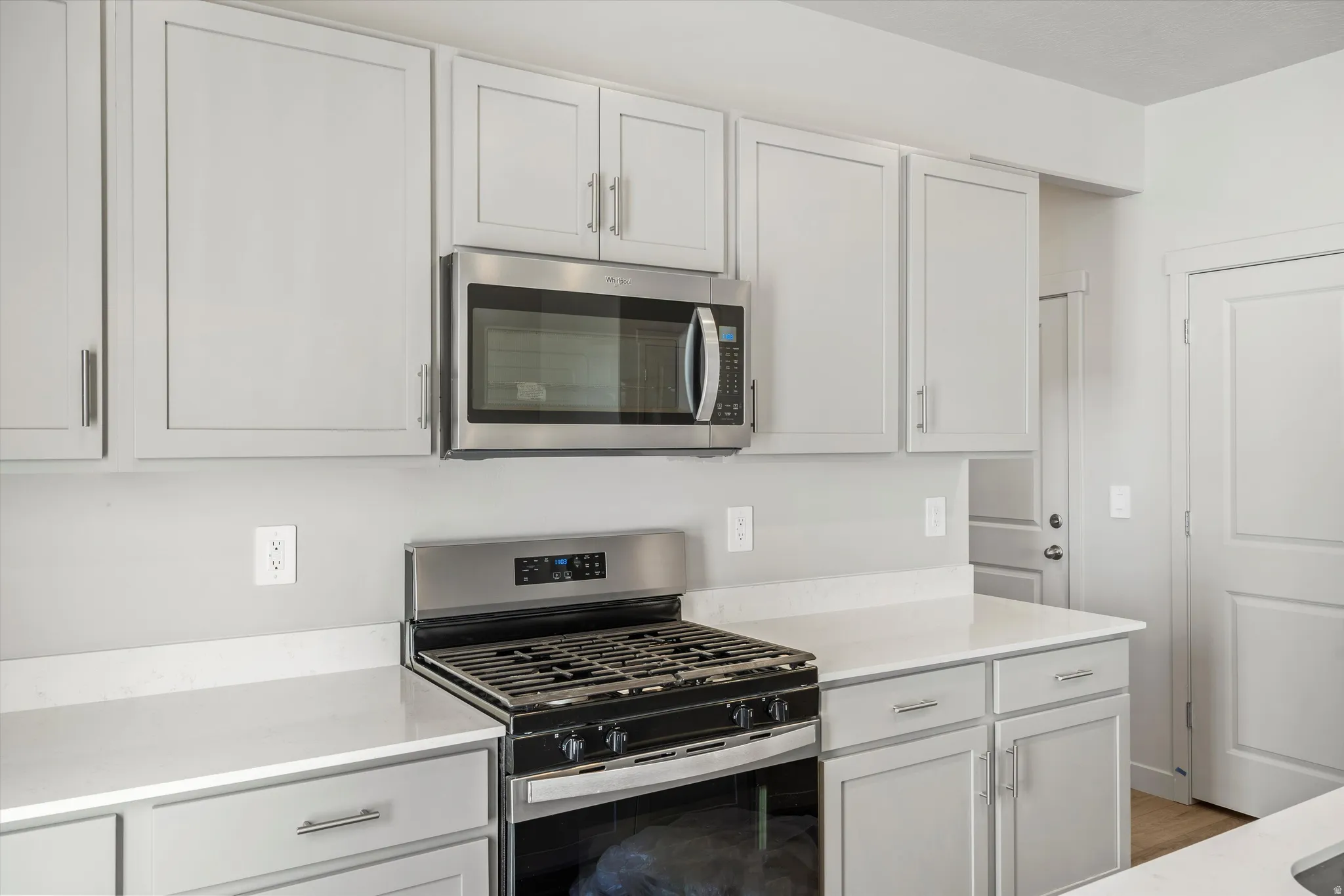 **DISCLAIMER** Interior package & color may vary. Kitchen with stainless steel appliances, light stone countertops, and white cabinetry