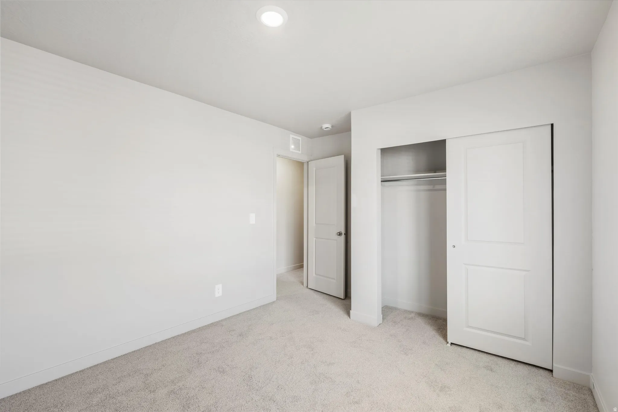 **DISCLAIMER** Interior package & color may vary. Unfurnished bedroom featuring light colored carpet and a closet