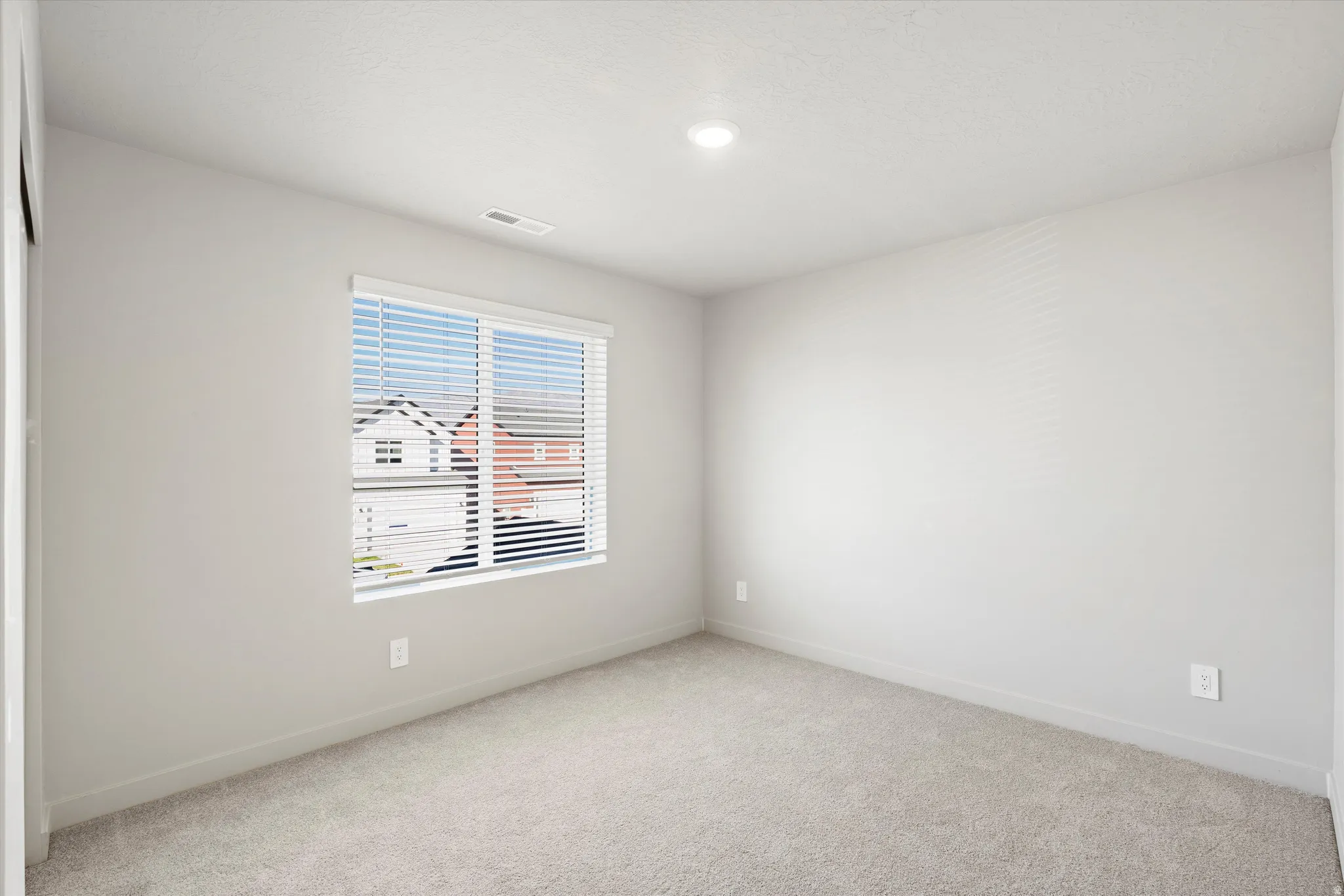 **DISCLAIMER** Interior package & color may vary. Spare room featuring light colored carpet and baseboards