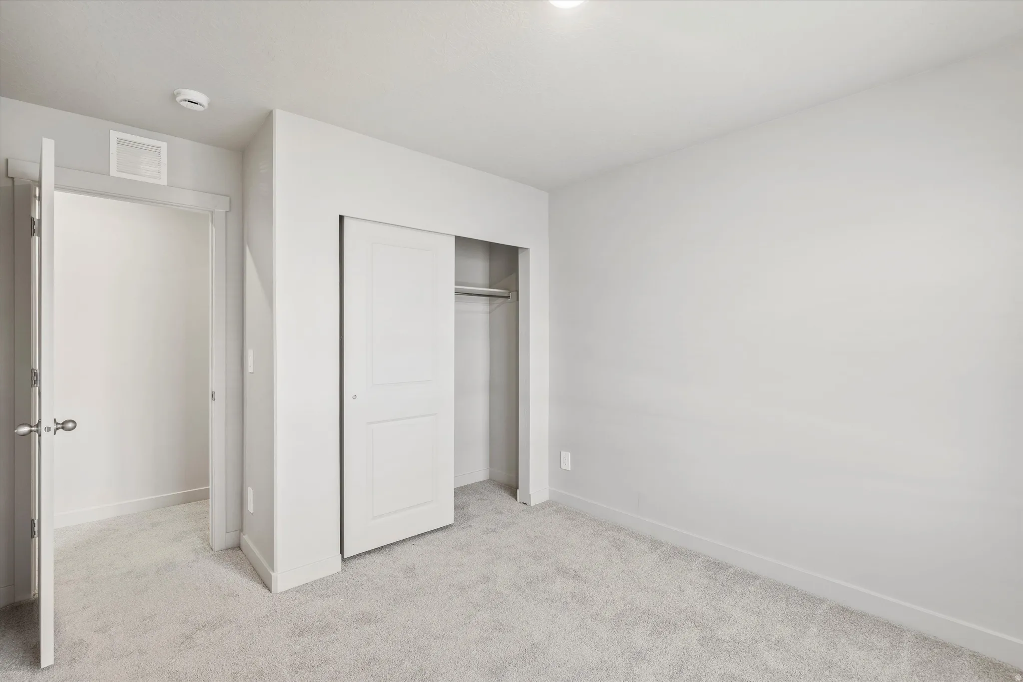 **DISCLAIMER** Interior package & color may vary. Unfurnished bedroom with light carpet and a closet
