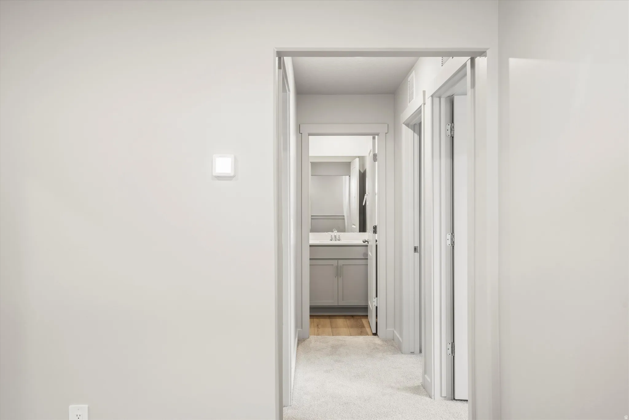 **DISCLAIMER** Interior package & color may vary. Hall with light carpet and a sink