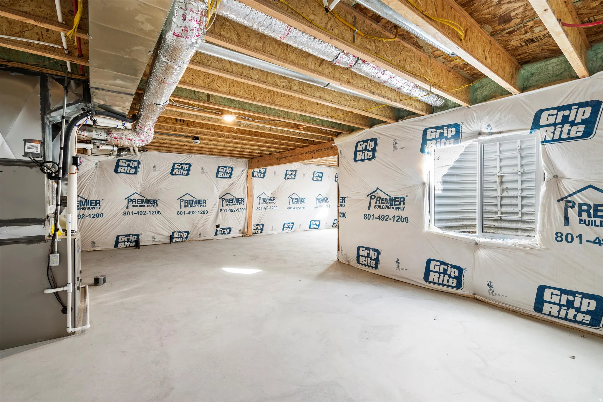 Unfinished below grade area featuring heating unit
