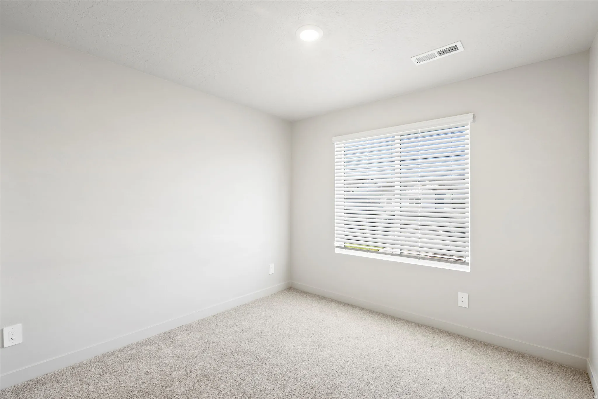 **DISCLAIMER** Interior package & color may vary. Spare room featuring light colored carpet and baseboards