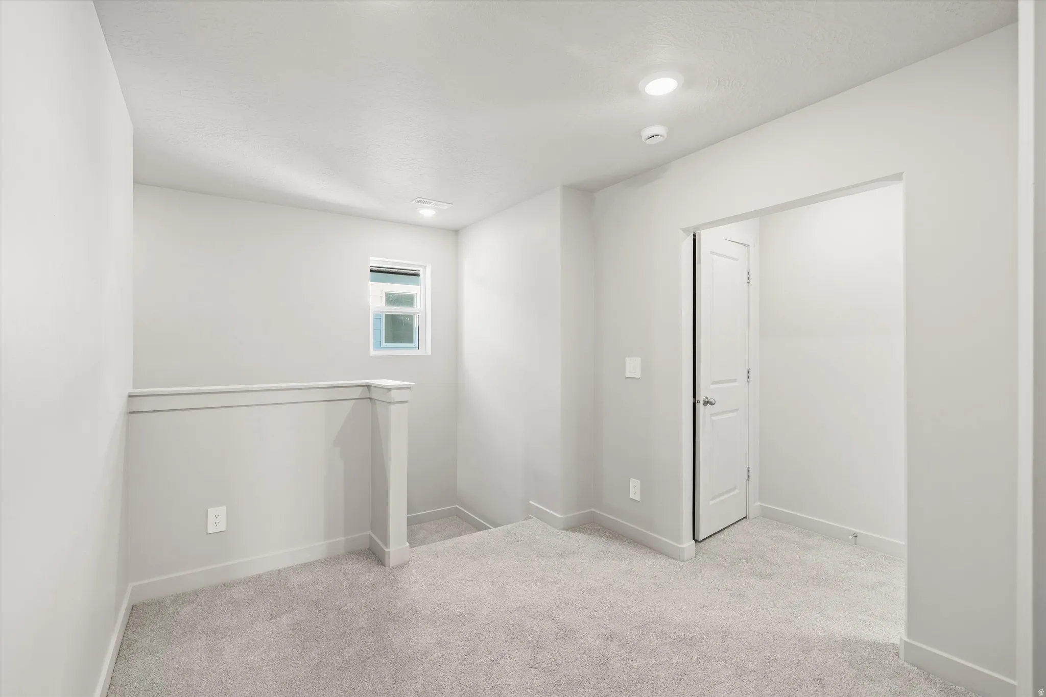 **DISCLAIMER** Interior package & color may vary. Spare room with light colored carpet and baseboards