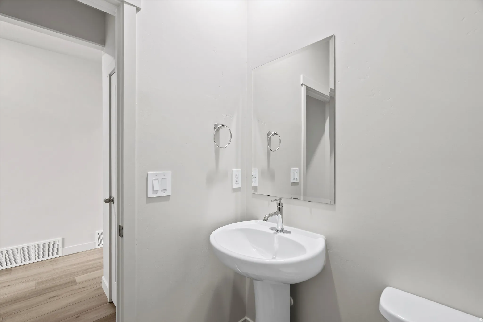 Bathroom featuring toilet and light wood-style floors
