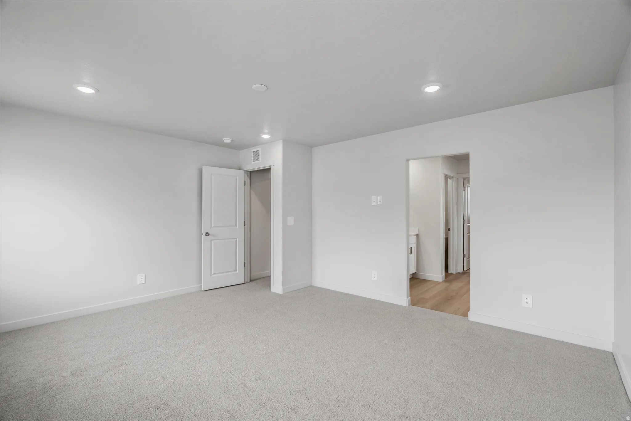 Unfurnished bedroom featuring light colored carpet and recessed lighting