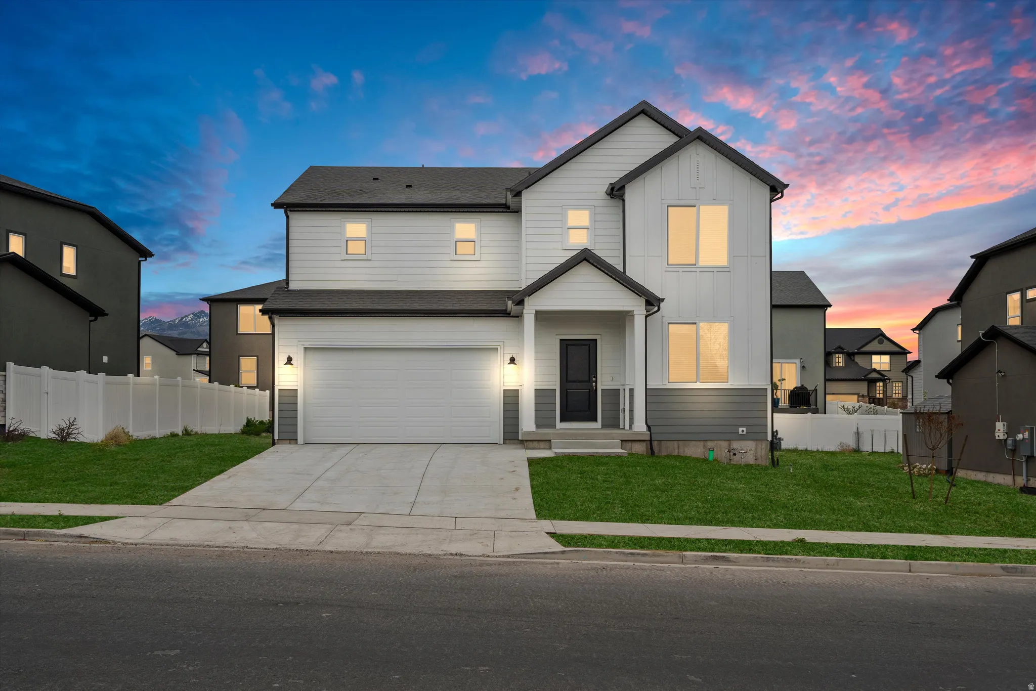 View of front of house with board and batten siding, concrete driveway, and a garage