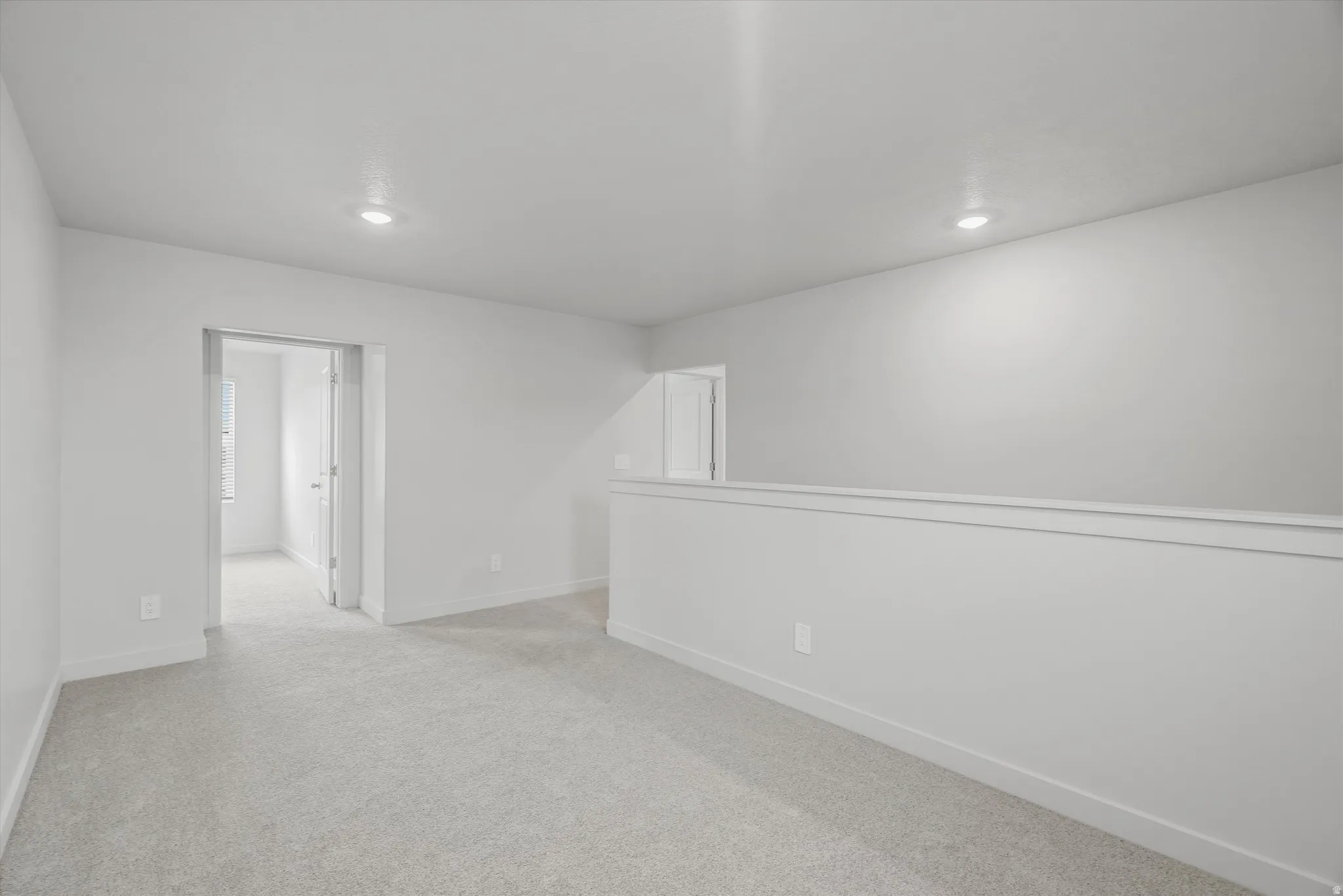 Spare room with light colored carpet and recessed lighting