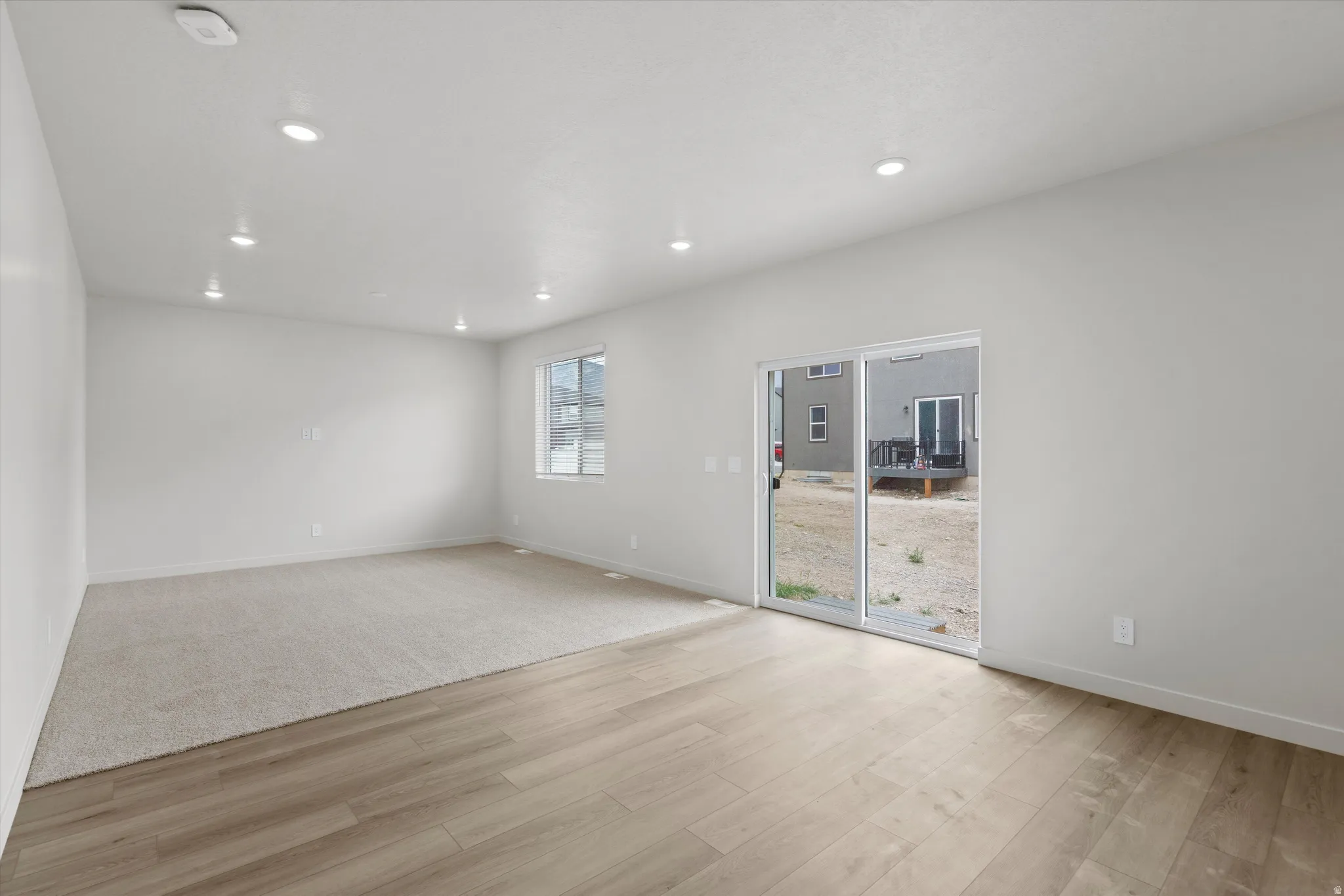 Spare room with light wood-style flooring, recessed lighting, and a smoke detector