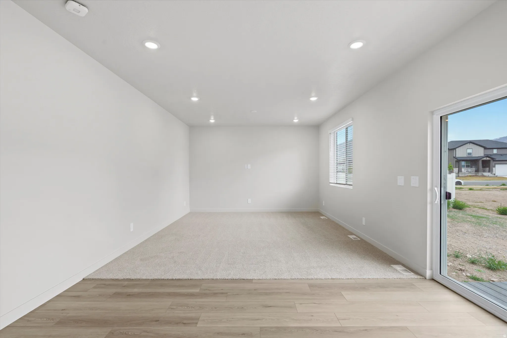 Unfurnished room featuring light wood-style flooring, recessed lighting, and a smoke detector