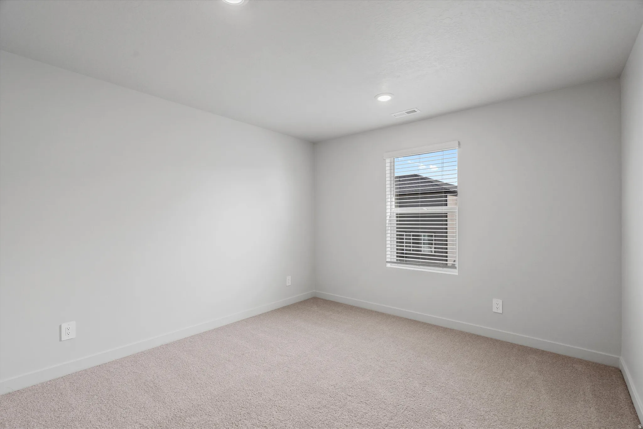 Unfurnished room with light carpet and recessed lighting