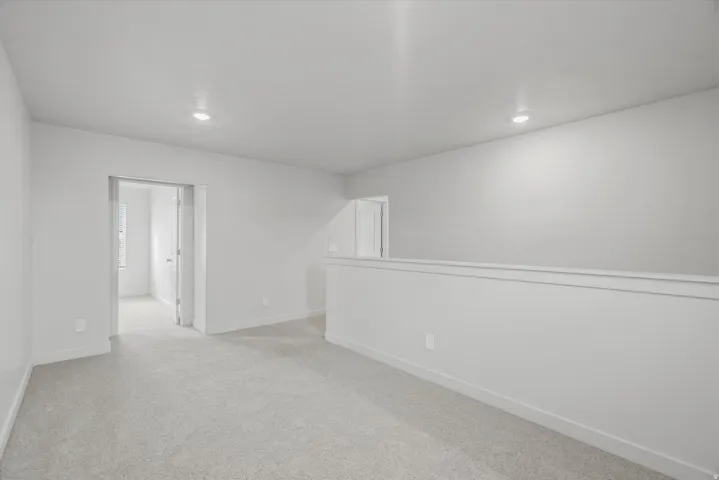 Spare room with light colored carpet and recessed lighting