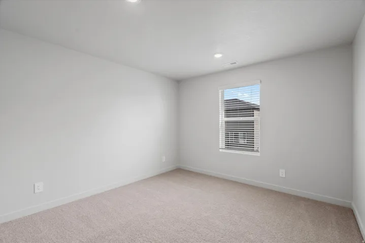 Unfurnished room with light carpet and recessed lighting