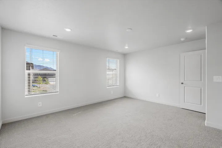Empty room featuring light carpet and recessed lighting