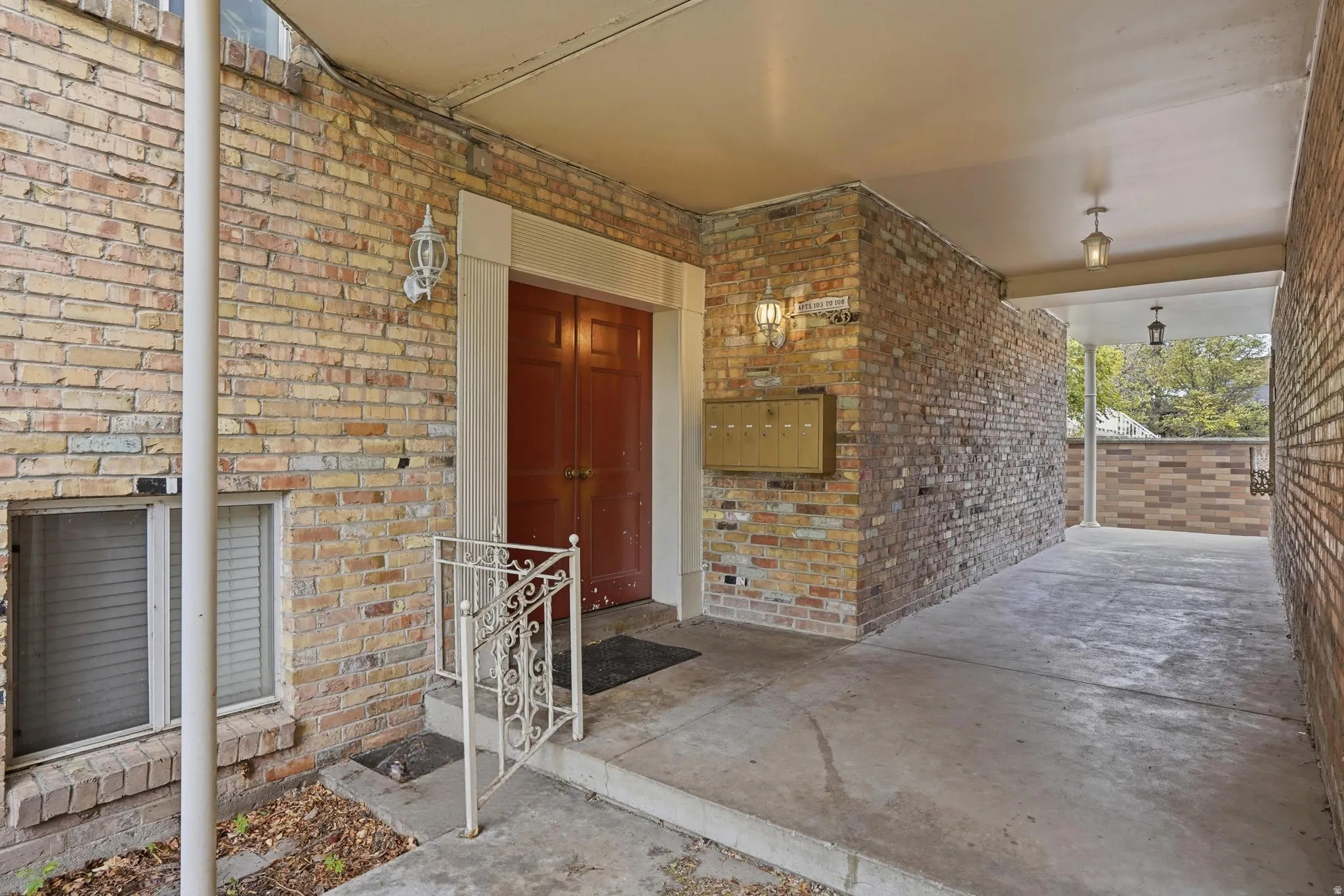 View of exterior entry featuring brick siding