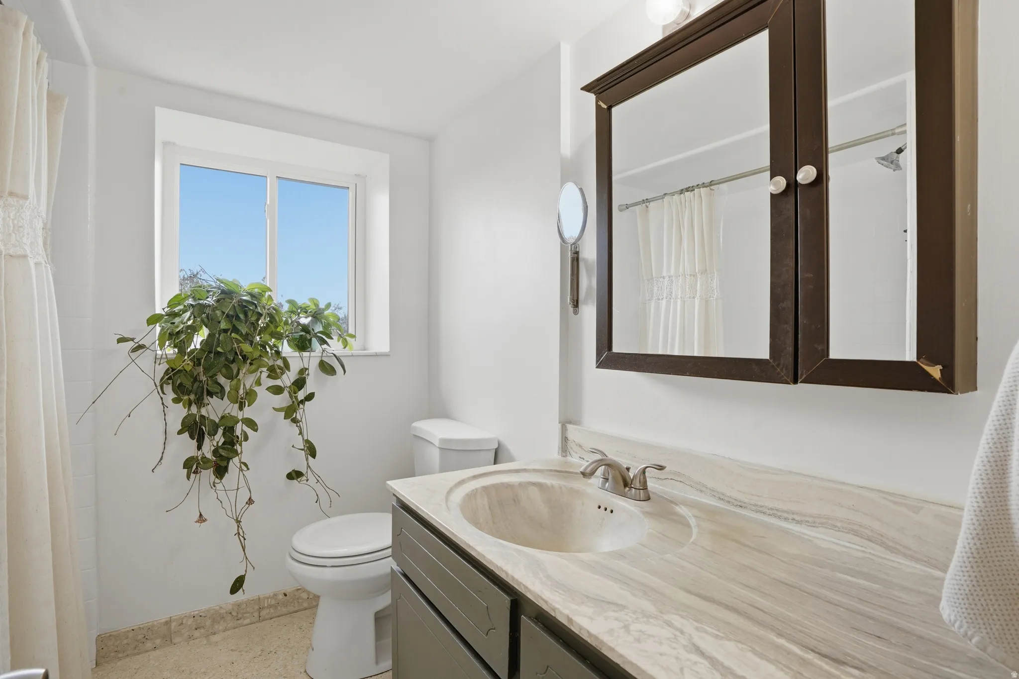 Bathroom with vanity and curtained shower