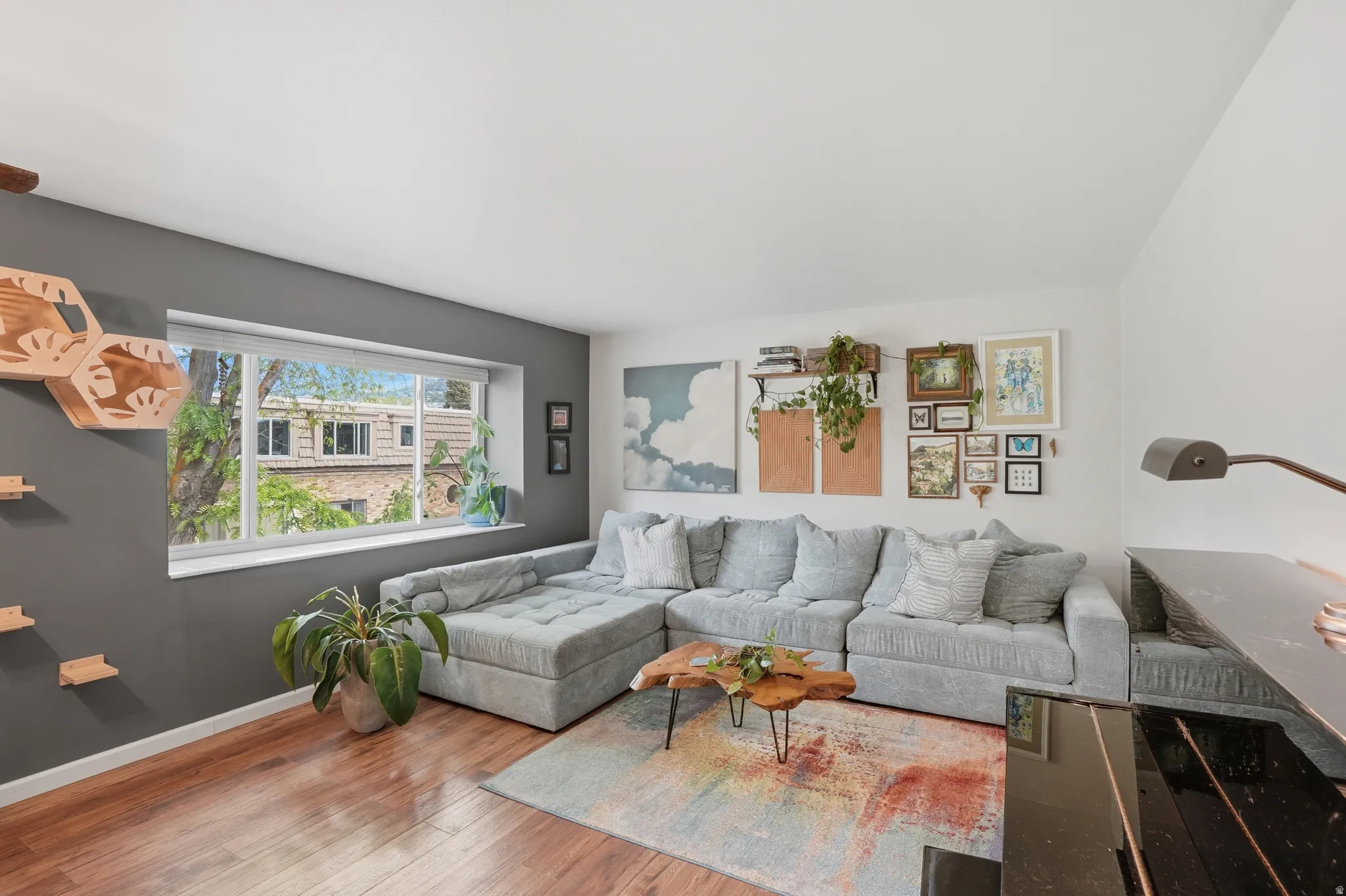 Living room featuring hardwood / wood-style flooring and baseboards