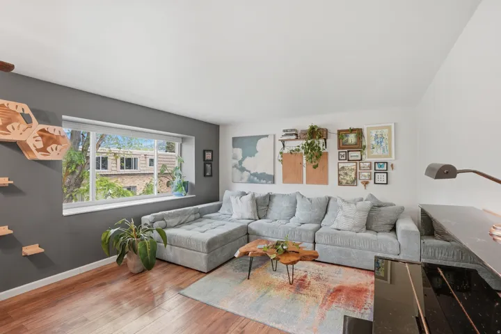 Living room featuring hardwood / wood-style flooring and baseboards