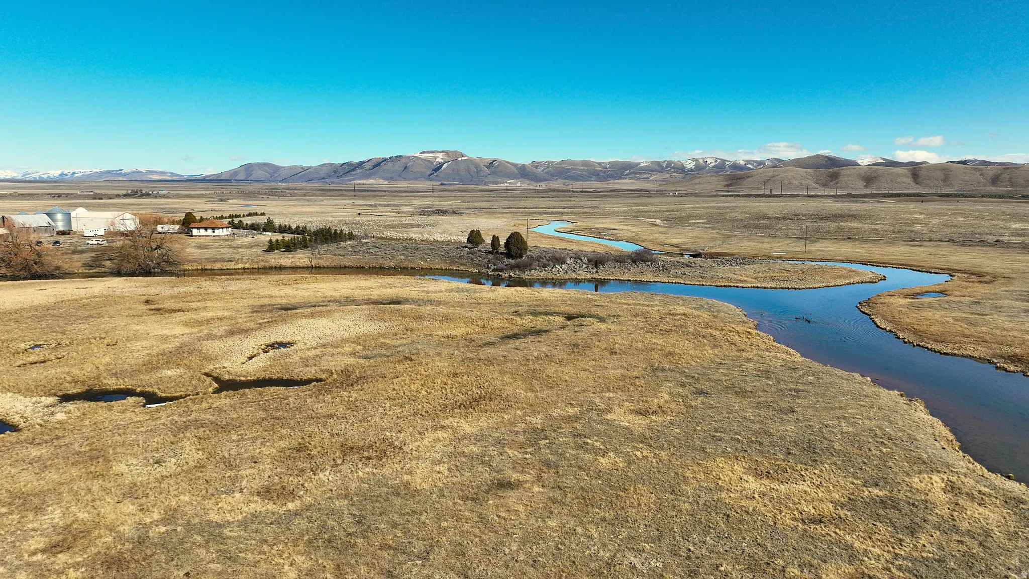 View of mountain backdrop featuring a nearby body of water
