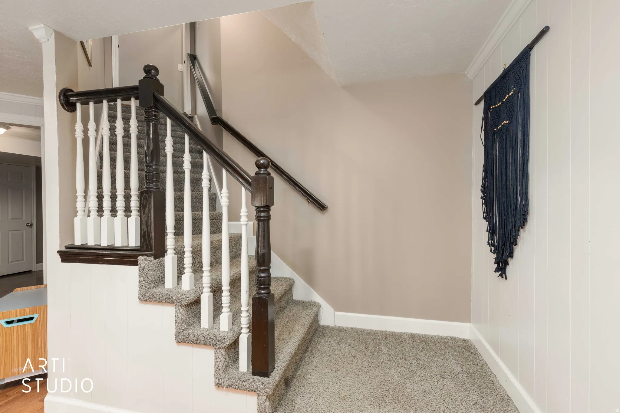 Stairs featuring carpet and crown molding