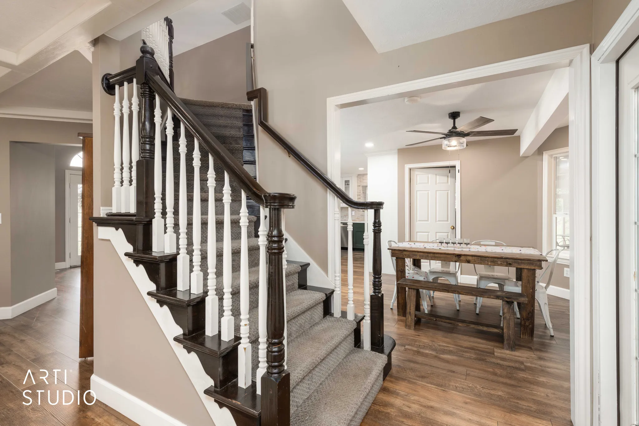 Staircase featuring wood finished floors and a ceiling fan