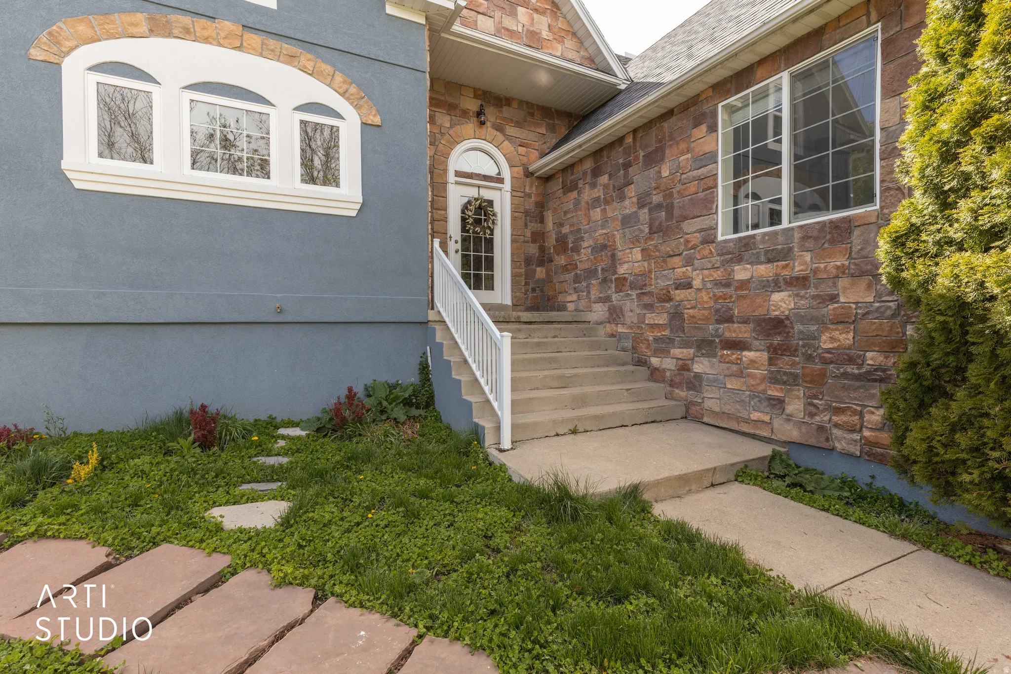 View of exterior entry featuring stone siding