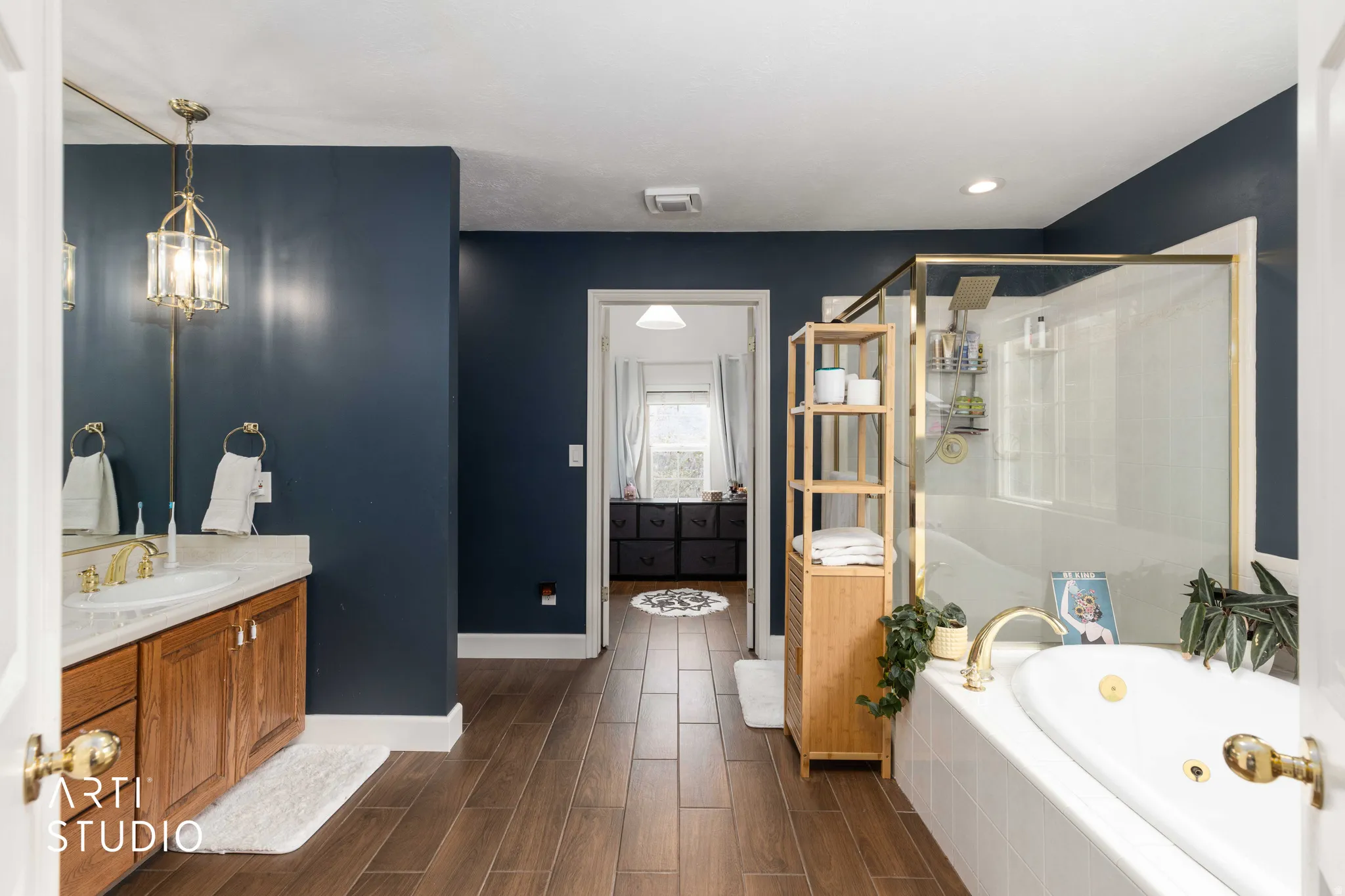 Full bathroom with vanity, wood tiled floors, a jetted tub, and a stall shower