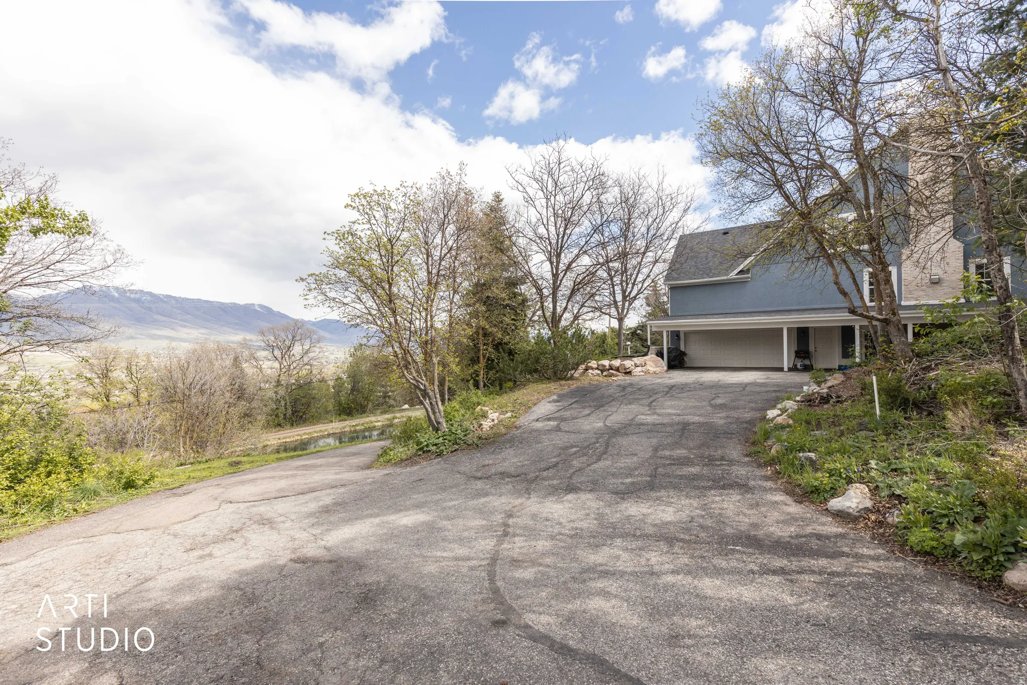 View of asphalt driveway with a mountain view
