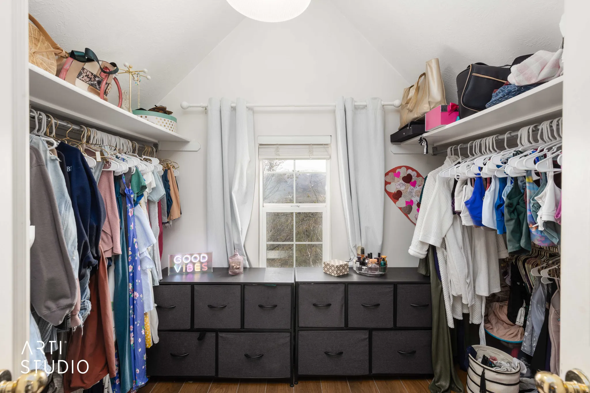Walk in closet featuring dark wood finished floors