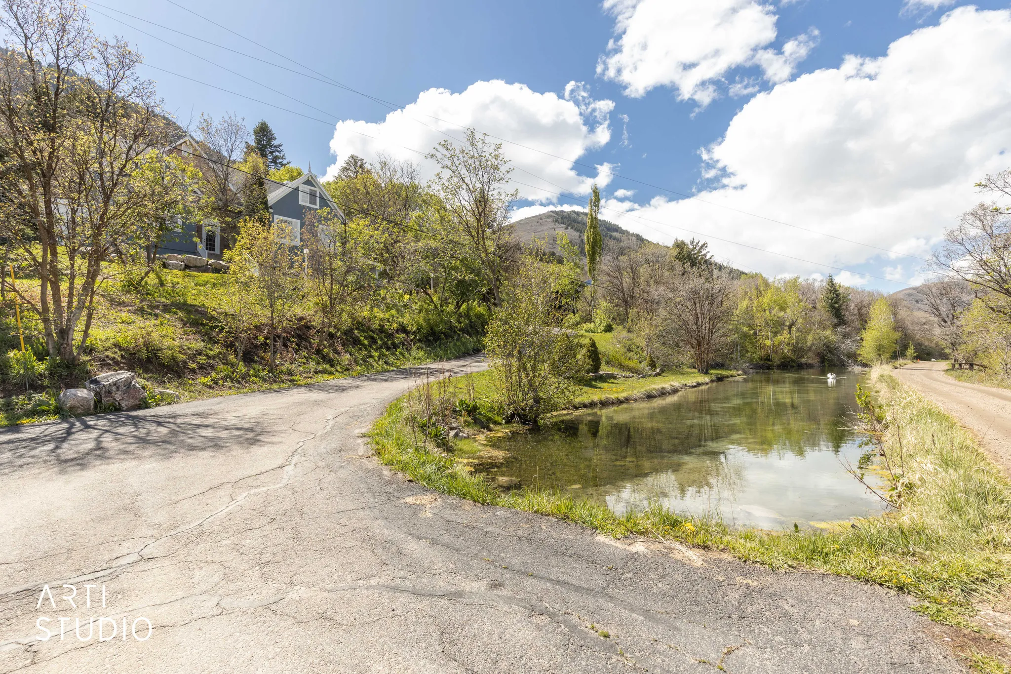 View of asphalt street with a water and mountain view