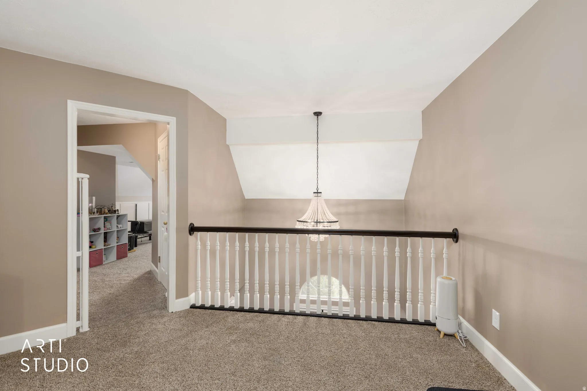 Corridor with carpet flooring and lofted ceiling