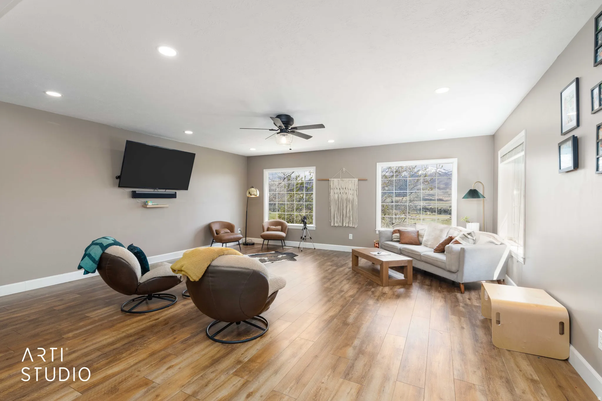 Living room with wood-type flooring, ceiling fan, and recessed lighting
