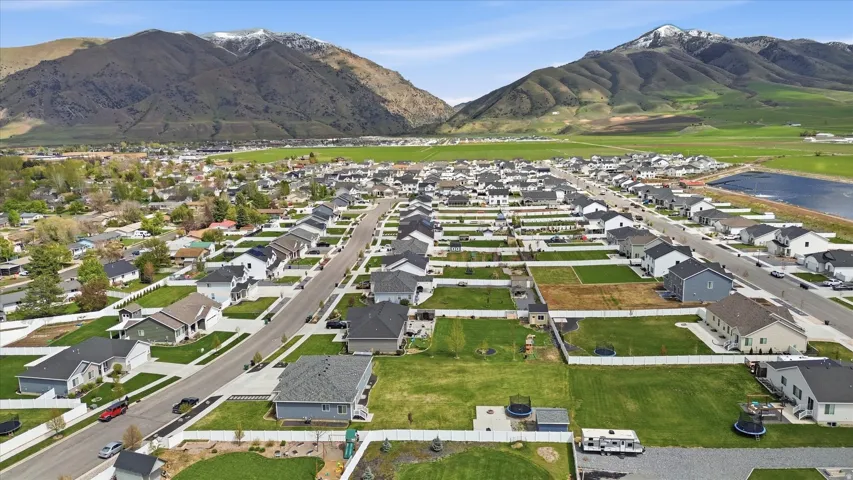 Aerial overview of property's location featuring nearby suburban area and mountains