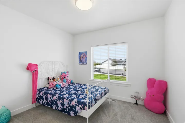 Bedroom 3 featuring baseboards and light carpet