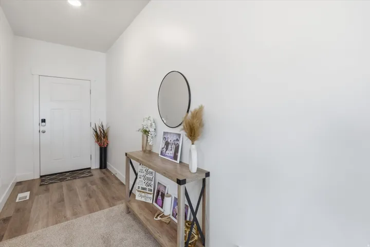 Foyer with light wood-style flooring and baseboards