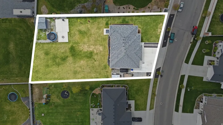 Aerial view of residential area with property parcel outlined