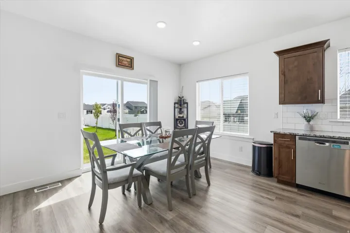 Dining room with light wood-type flooring and recessed lighting