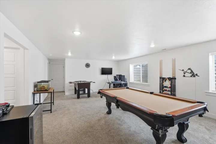 Rec room with light carpet and billiards table