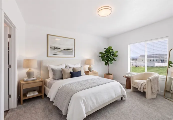 Bedroom with light colored carpet