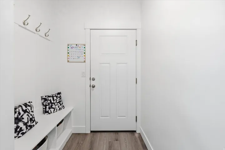 Mudroom with light wood-type flooring and baseboards