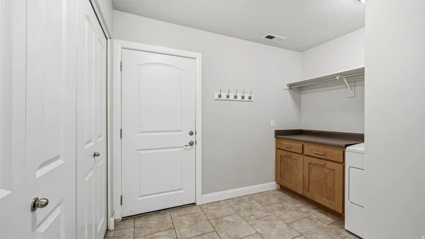 Laundry and Mud Room with garage door.