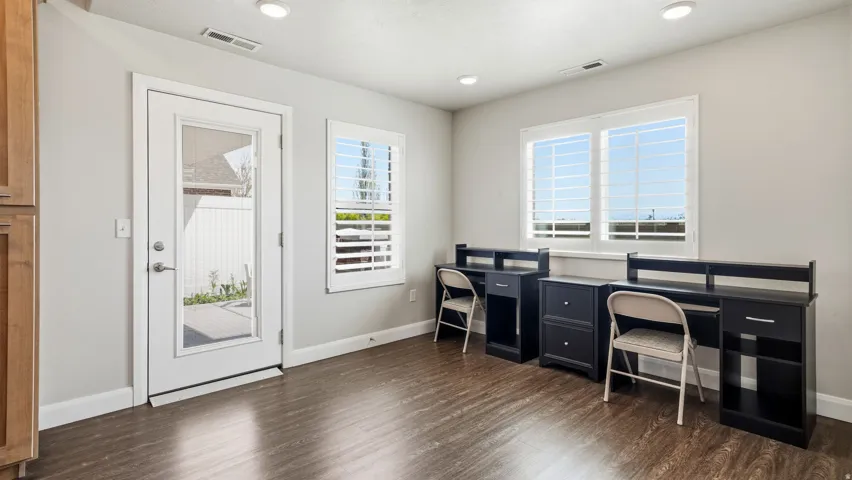 Office space featuring dark wood-style flooring and recessed lighting