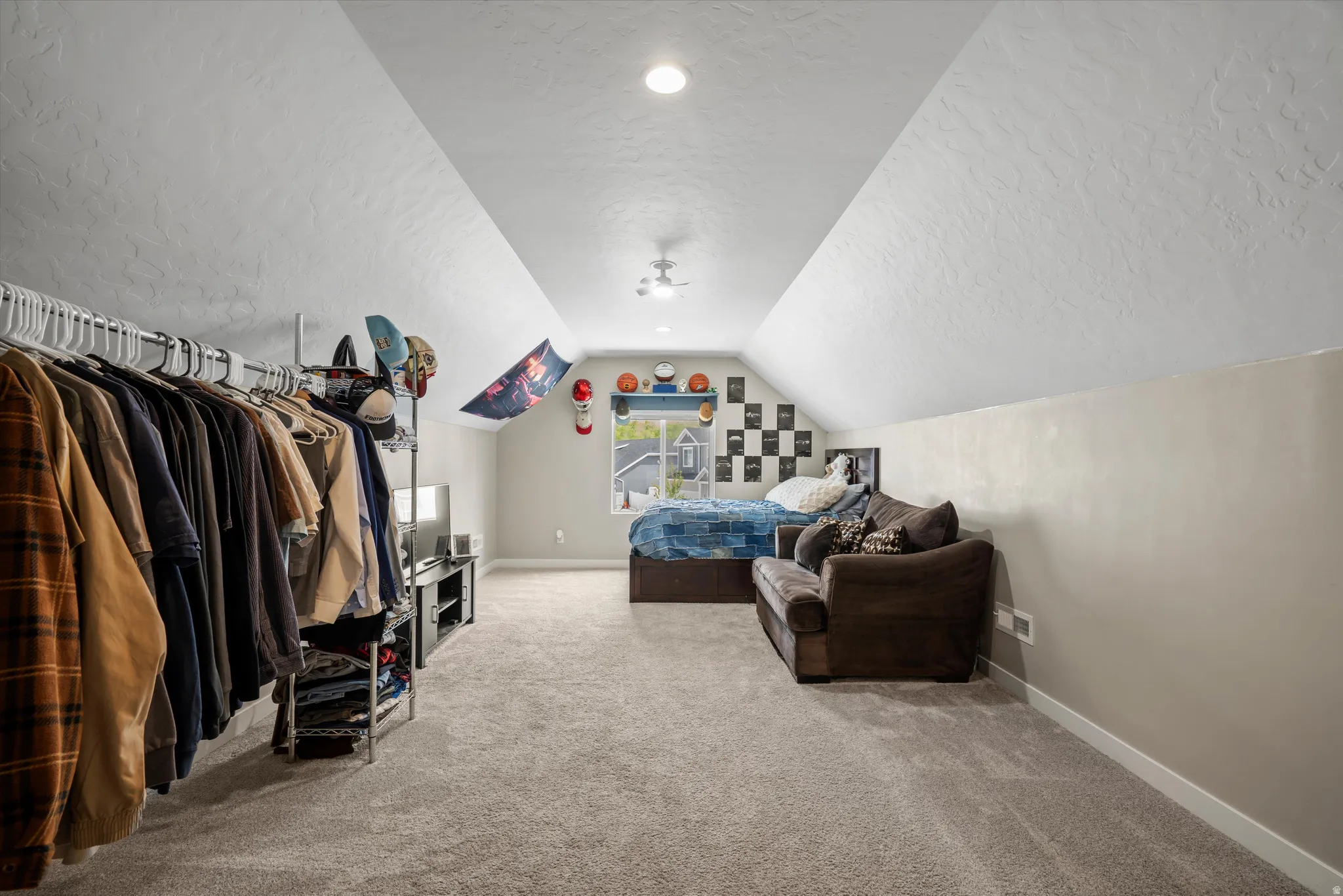 Bedroom with a textured ceiling and light carpet