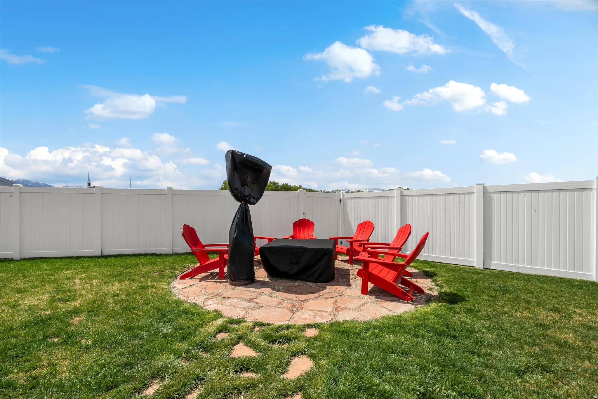 Fenced backyard featuring a patio